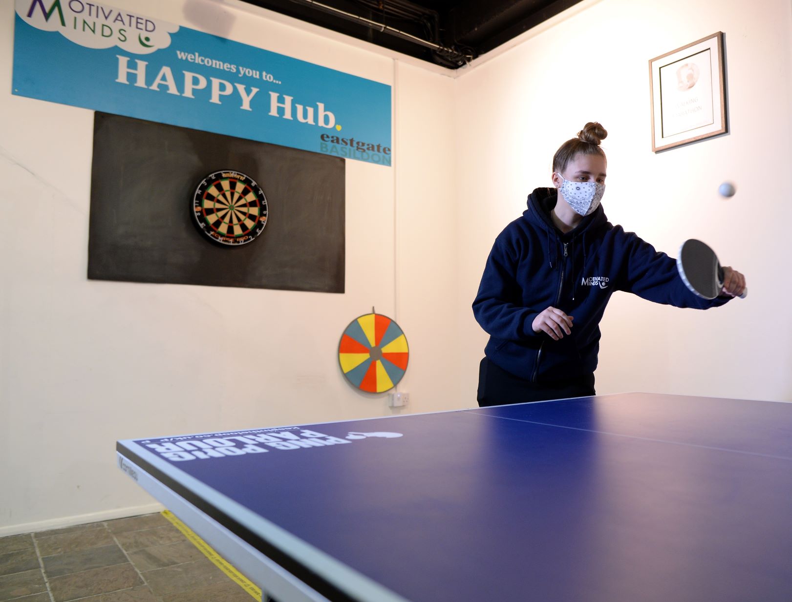 Lady playing table tennis at the Happy Hub